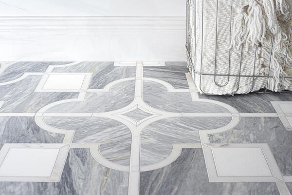 Place des Vosges Grandiose, a waterjet stone mosaic shown in honed Cirrus, Calacatta Monet and Thassos, is part of the Ville Lumière collection by Caroline Beaupère
