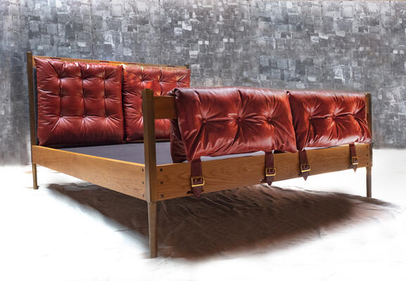 Campanha bed: Classical campaign furniture creatively mixes with midcentury modernism in the Campanha collection. Infused with a rugged-meets-refined aesthetic, tufted leather upholstery details are offset by careful and precise facets of turned brass and oiled wood


