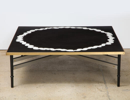 Couronne table: Inspired by the work of art deco master Maxime Olde, the Couronne table showcases a harmony of intersections. The base is a mix of metals: gunmetal steel, brushed aluminum stretchers, and screw details in polished brass. Dark, smooth resin grounds the elegant embedded Coquille d’Oeuf (eggshell mosaic) top, which is trimmed by a satin brass frame