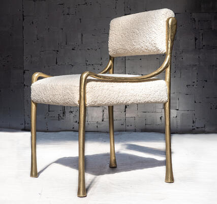 The Giac Side Chair is defined by its sinuous cast-aluminum frame and elegant form