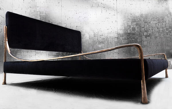 The Giac Bed is defined by its sinuous cast-aluminum frame and elegant form.