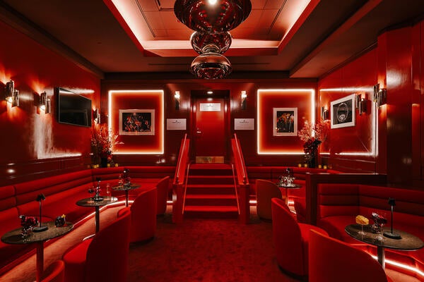 Inspired by the allure of a speakeasy, the space is a hidden jewel box within the bustling arena
